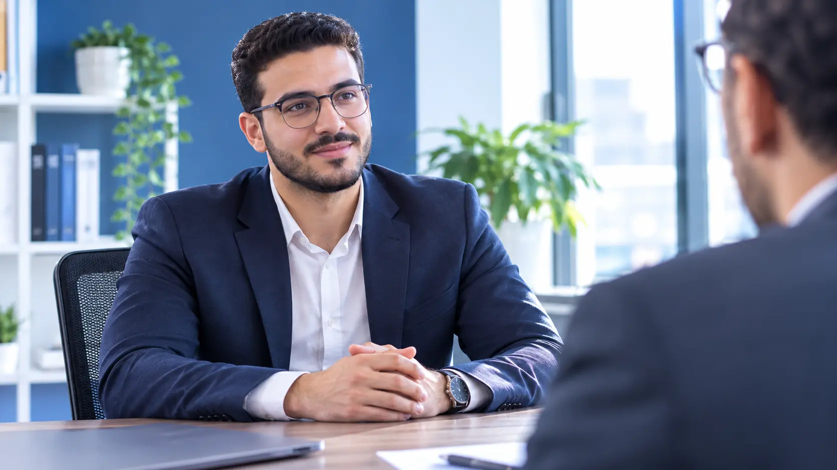 A candidate showing confident body language in an interview with eye contact and upright posture